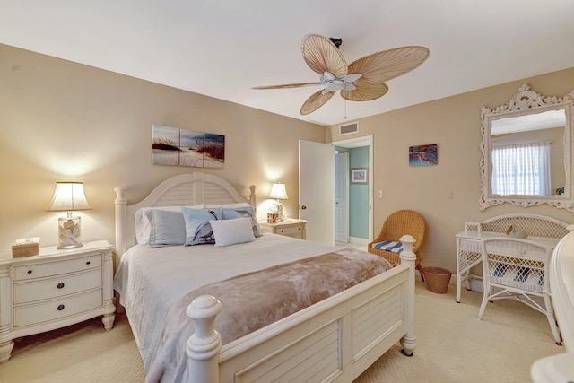 bedroom featuring ceiling fan, visible vents, and light carpet