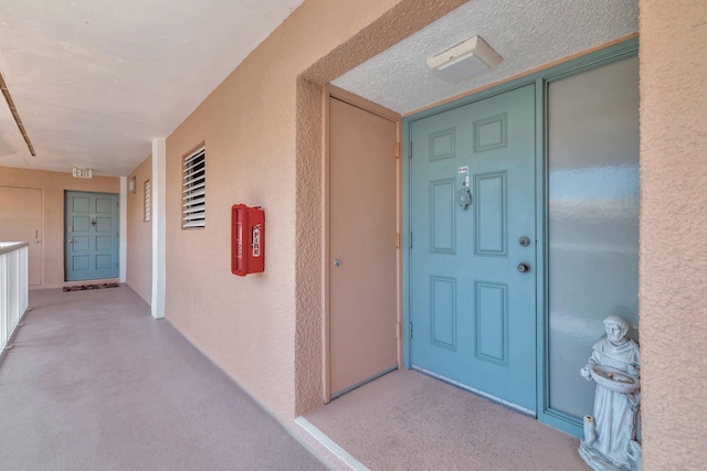 view of exterior entry featuring stucco siding