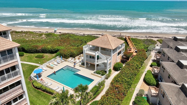 birds eye view of property featuring a beach view and a water view