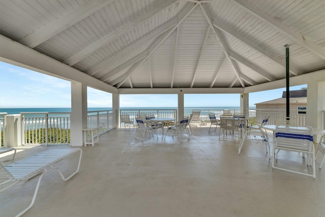 view of patio / terrace featuring a gazebo, outdoor dining space, and a water view