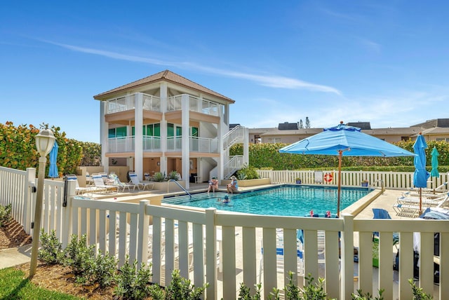 community pool featuring fence private yard and a patio area