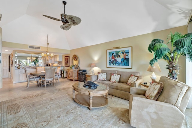 living room featuring high vaulted ceiling, ceiling fan with notable chandelier, and visible vents