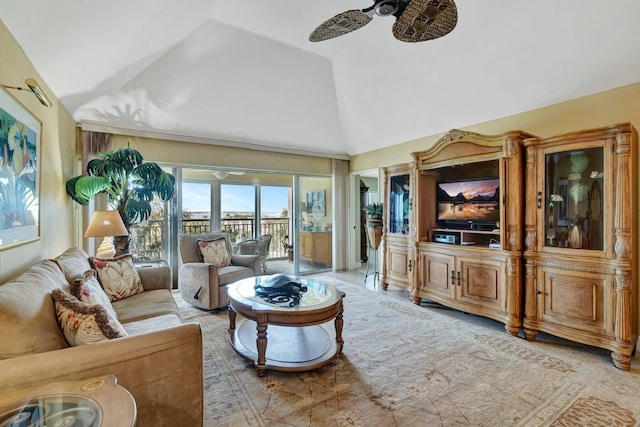 living area featuring a ceiling fan and high vaulted ceiling