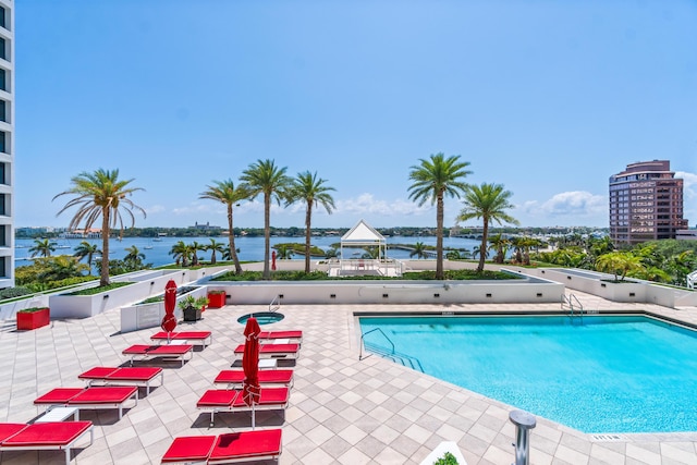 view of pool featuring a water view, a gazebo, and a patio area
