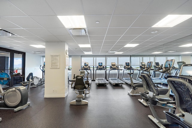 exercise room with plenty of natural light and a drop ceiling