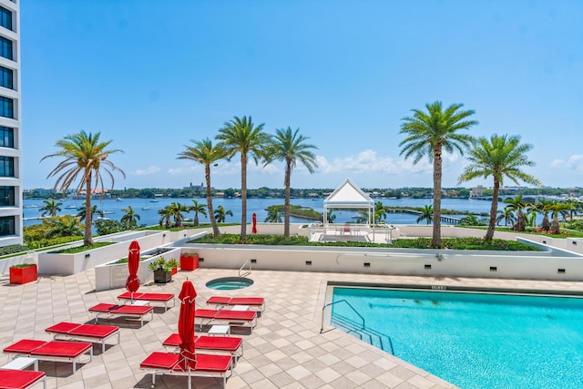 pool featuring a water view, a gazebo, and a patio
