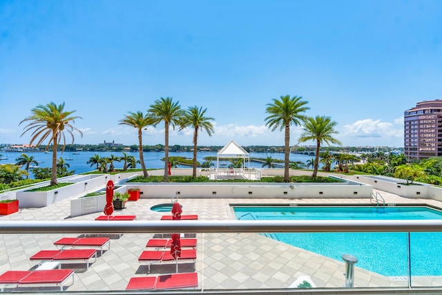 view of pool featuring a gazebo, a water view, and a patio