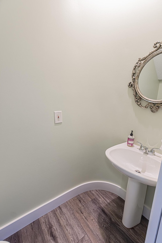 bathroom featuring baseboards and wood finished floors