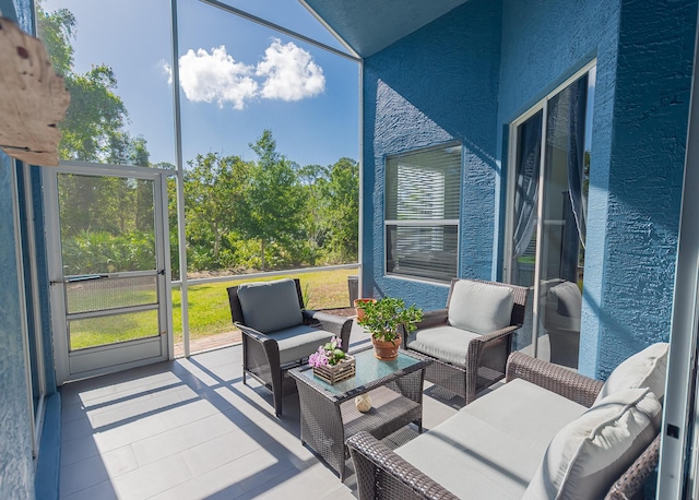 sunroom with an outdoor living space