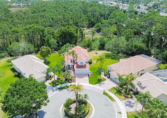 birds eye view of property featuring a wooded view