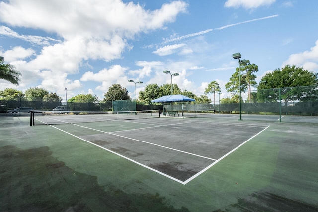 view of sport court featuring fence