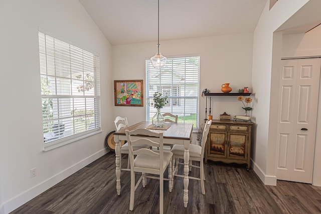 dining area featuring baseboards, vaulted ceiling, dark wood-style floors, and a wealth of natural light
