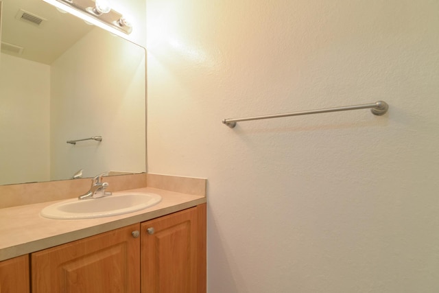 bathroom with visible vents and vanity