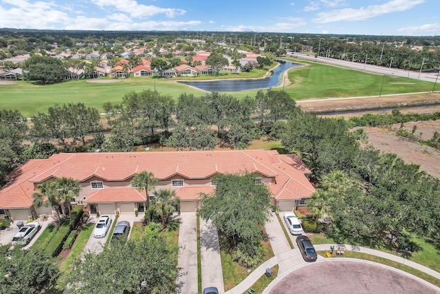 aerial view with view of golf course, a water view, and a residential view