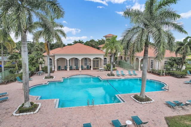 community pool featuring a patio area and fence
