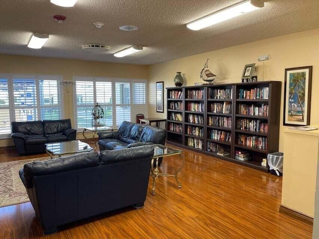 living room with wood finished floors and a textured ceiling