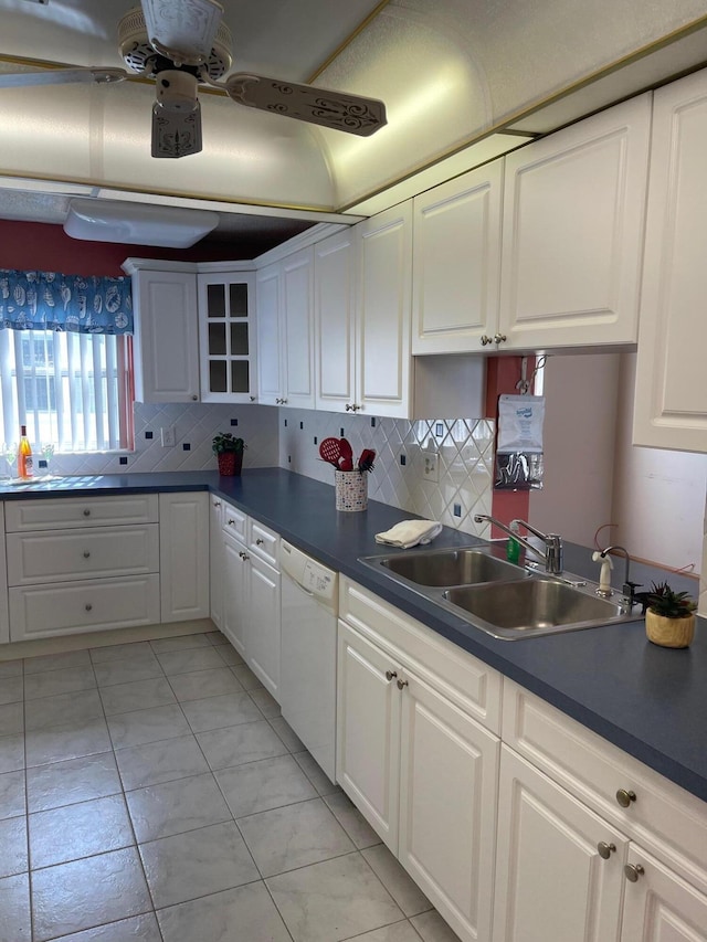 kitchen with white cabinetry, white dishwasher, tasteful backsplash, and a sink
