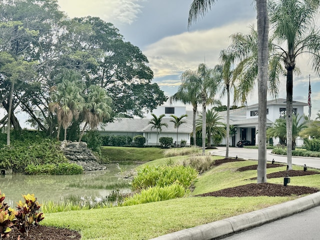view of property's community with a lawn