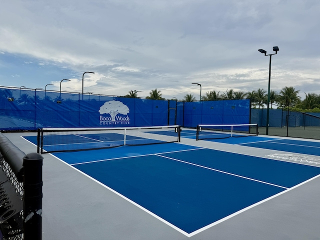 view of tennis court with fence and community basketball court