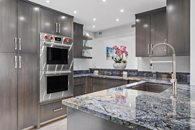 3610 S Ocean Blvd Unit 405, South Palm Beach, FL 33480 - kitchen with double oven, a sink, dark stone countertops, open shelves, and recessed lighting