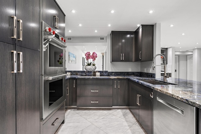 3610 S Ocean Blvd Unit 405, South Palm Beach, FL 33480 - kitchen with a sink, stainless steel appliances, light marble finish floors, dark stone countertops, and recessed lighting
