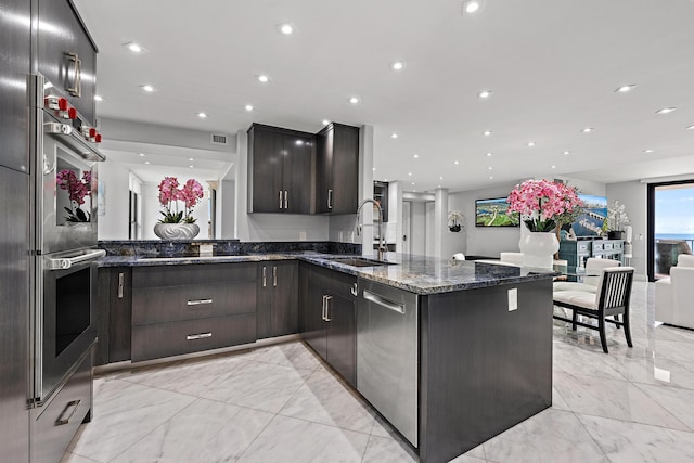3610 S Ocean Blvd Unit 405, South Palm Beach, FL 33480 - kitchen with a sink, light marble finish floors, appliances with stainless steel finishes, a peninsula, and recessed lighting