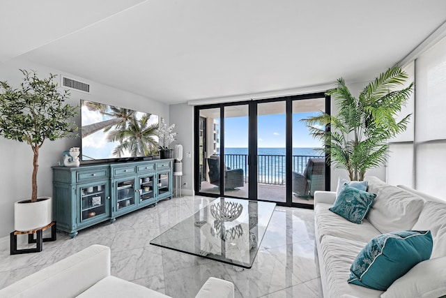 3610 S Ocean Blvd Unit 405, South Palm Beach, FL 33480 - living room with marble tiled flooring, a wall of windows, and baseboards