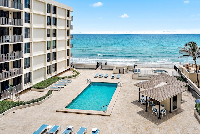 3610 S Ocean Blvd Unit 405, South Palm Beach, FL 33480 - community pool with view of water and beach and a patio