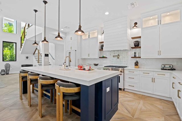 kitchen with recessed lighting, open shelves, light countertops, visible vents, and gas stove