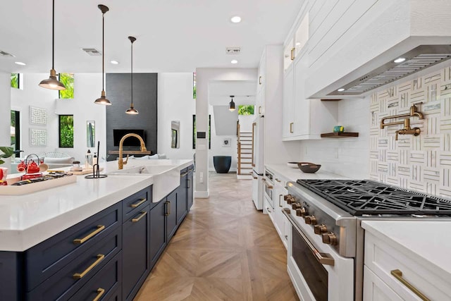 kitchen featuring light countertops, gas stove, white cabinetry, and custom range hood