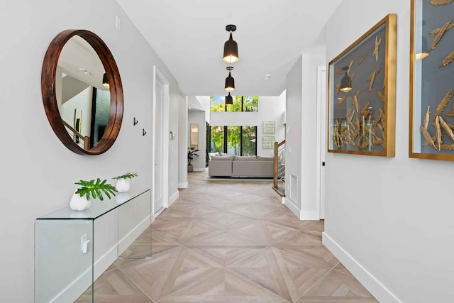 corridor featuring visible vents and baseboards