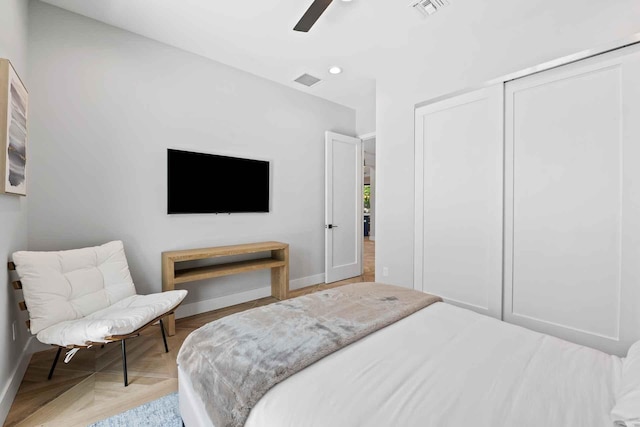 bedroom with visible vents, baseboards, and a closet