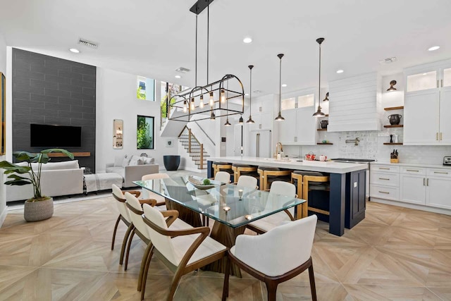 dining room with plenty of natural light, visible vents, recessed lighting, and stairs