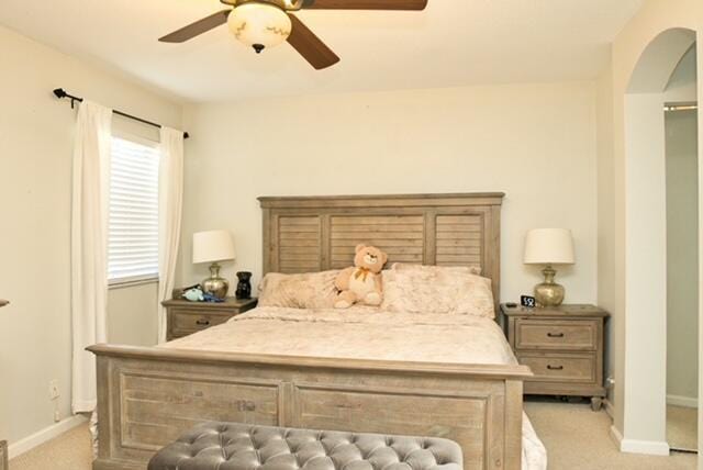 2102 Little Torch St, Riviera Beach, FL 33407 - bedroom with arched walkways, baseboards, light colored carpet, and ceiling fan