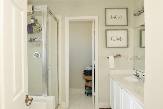 2102 Little Torch St, Riviera Beach, FL 33407 - bathroom with double vanity, tile patterned floors, a shower stall, and a sink