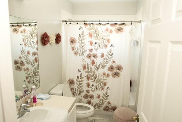 2102 Little Torch St, Riviera Beach, FL 33407 - bathroom featuring vanity, shower / bath combo with shower curtain, and toilet