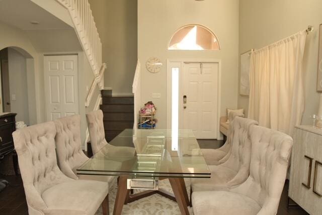 2102 Little Torch St, Riviera Beach, FL 33407 - dining space featuring stairway, arched walkways, and a towering ceiling