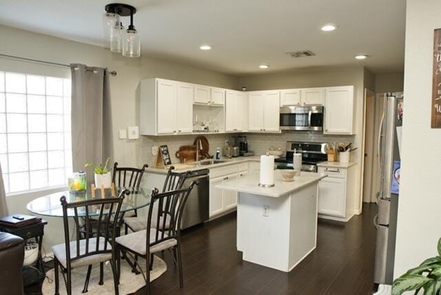 2102 Little Torch St, Riviera Beach, FL 33407 - kitchen featuring a center island, light countertops, white cabinetry, and appliances with stainless steel finishes