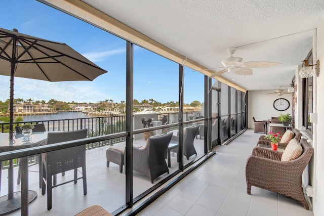 3420 S Ocean Blvd Unit 3W, Highland Beach, FL 33487 - sunroom / solarium featuring a water view, expansive windows, ceiling fan, and a textured ceiling