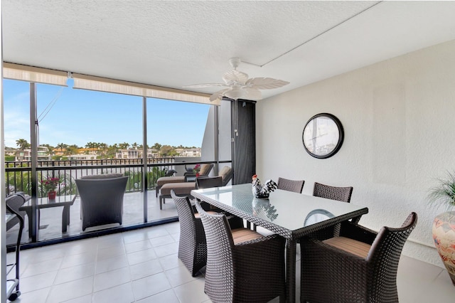 3420 S Ocean Blvd Unit 3W, Highland Beach, FL 33487 - dining room featuring a wall of windows, a ceiling fan, a textured wall, light tile patterned floors, and a textured ceiling