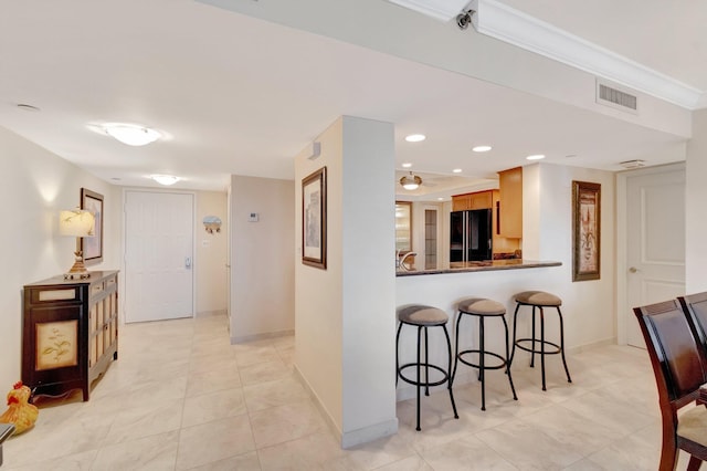 3420 S Ocean Blvd Unit 3W, Highland Beach, FL 33487 - kitchen with freestanding refrigerator, a breakfast bar area, light tile patterned flooring, baseboards, and recessed lighting