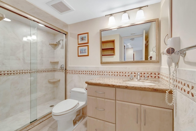 3420 S Ocean Blvd Unit 3W, Highland Beach, FL 33487 - full bathroom featuring tile walls, vanity, a stall shower, toilet, and tile patterned flooring