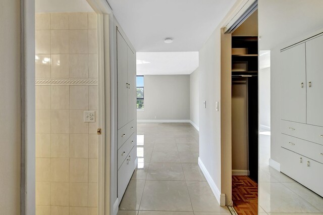 6372 La Costa Dr Unit 302, Boca Raton, FL 33433 - corridor featuring light tile patterned flooring and baseboards