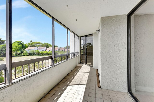 6372 La Costa Dr Unit 302, Boca Raton, FL 33433 - unfurnished sunroom with lofted ceiling and a residential view