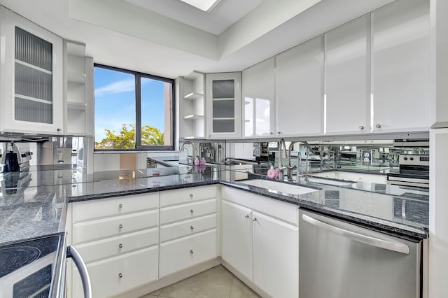 6372 La Costa Dr Unit 302, Boca Raton, FL 33433 - kitchen with dishwasher, a sink, white cabinetry, and dark stone countertops