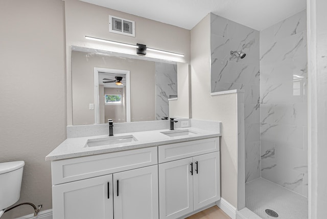 bathroom with visible vents, toilet, a marble finish shower, and a sink