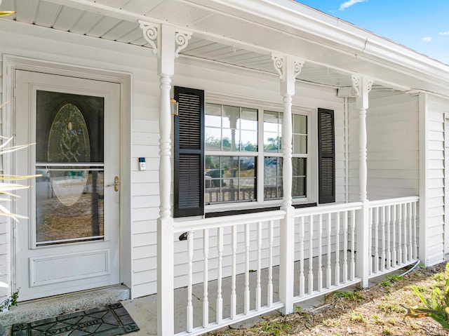 view of exterior entry with a porch