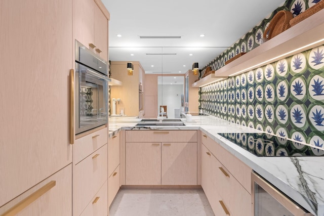 2773 S Ocean Blvd Unit 209, Palm Beach, FL 33480 - kitchen featuring beverage cooler, light brown cabinetry, oven, light stone counters, and black electric stovetop
