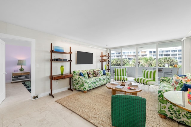 2773 S Ocean Blvd Unit 209, Palm Beach, FL 33480 - living room featuring a wall of windows and baseboards
