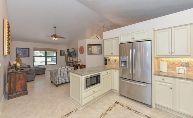 kitchen with stainless steel fridge, built in microwave, a peninsula, lofted ceiling, and ceiling fan